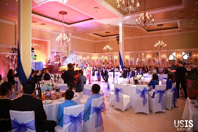 An entire view of the event room, professionally and elegantly decorated, attended by many guests